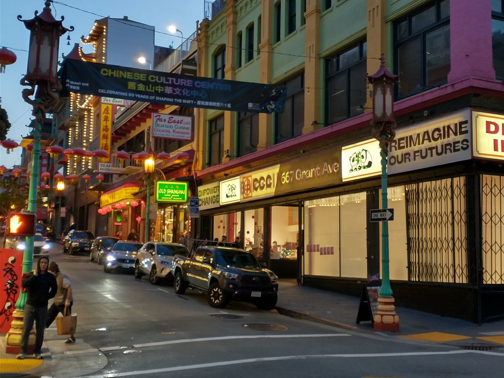 Chinatown at night, storefront says CCC and Reimagine our Futures