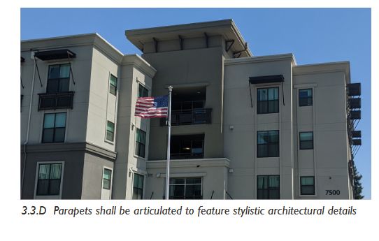 Photo of a gray multistory building with many corners, and a roof parapet. 3.3.D Parapets shall be articulated to feature stylistic architectural details
