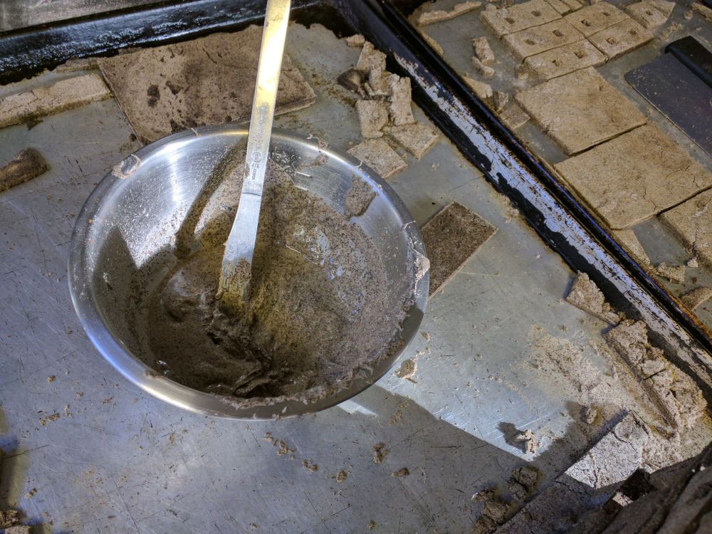 a couple of baking sheets with a gray concrete like batter and rectangles cut out