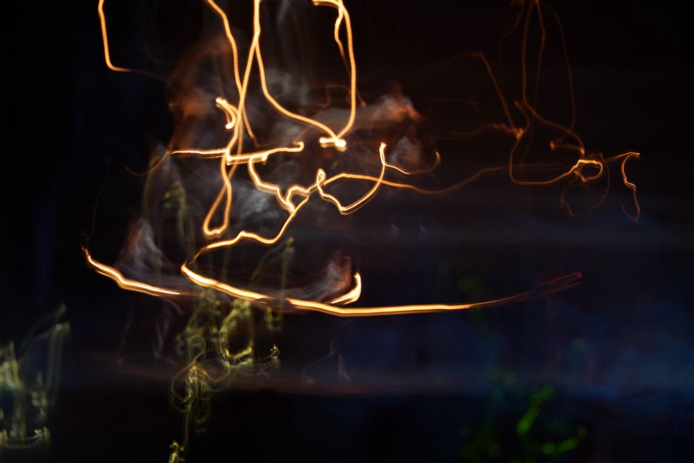 Squiggly lines. Tracers on a large stage from a swinging work light