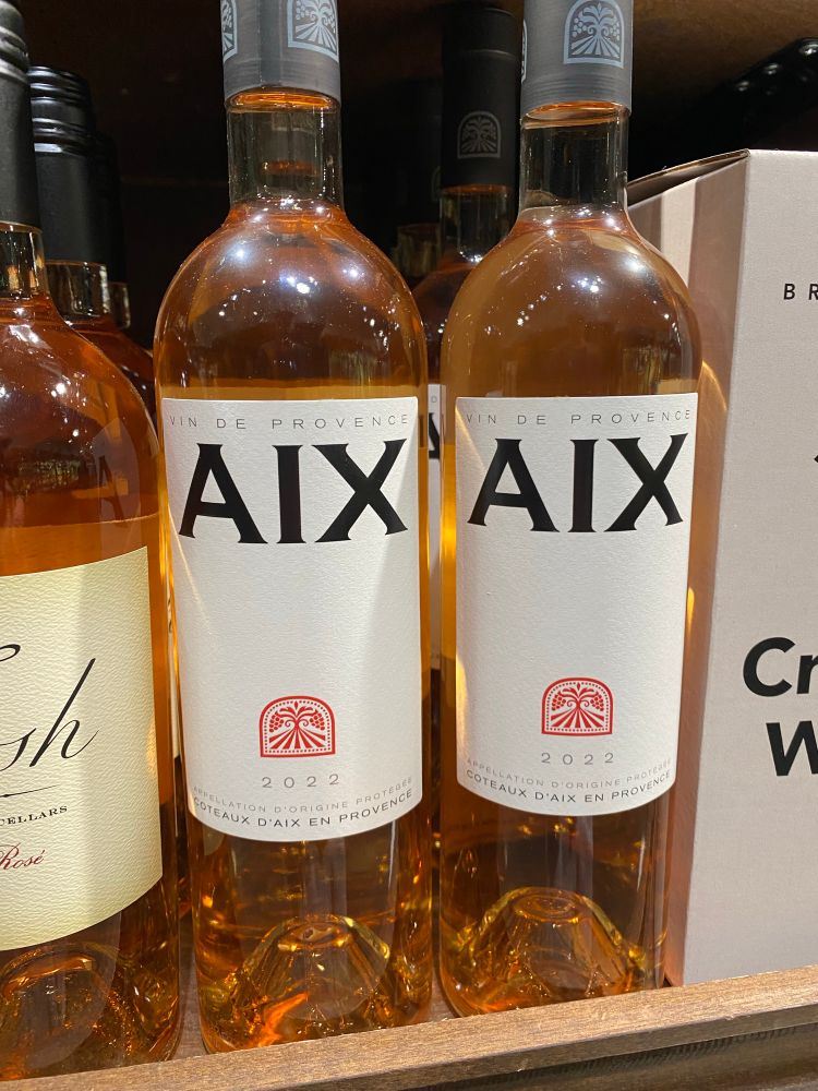 Two bottles of wine boldly labeled “AIX” in all caps