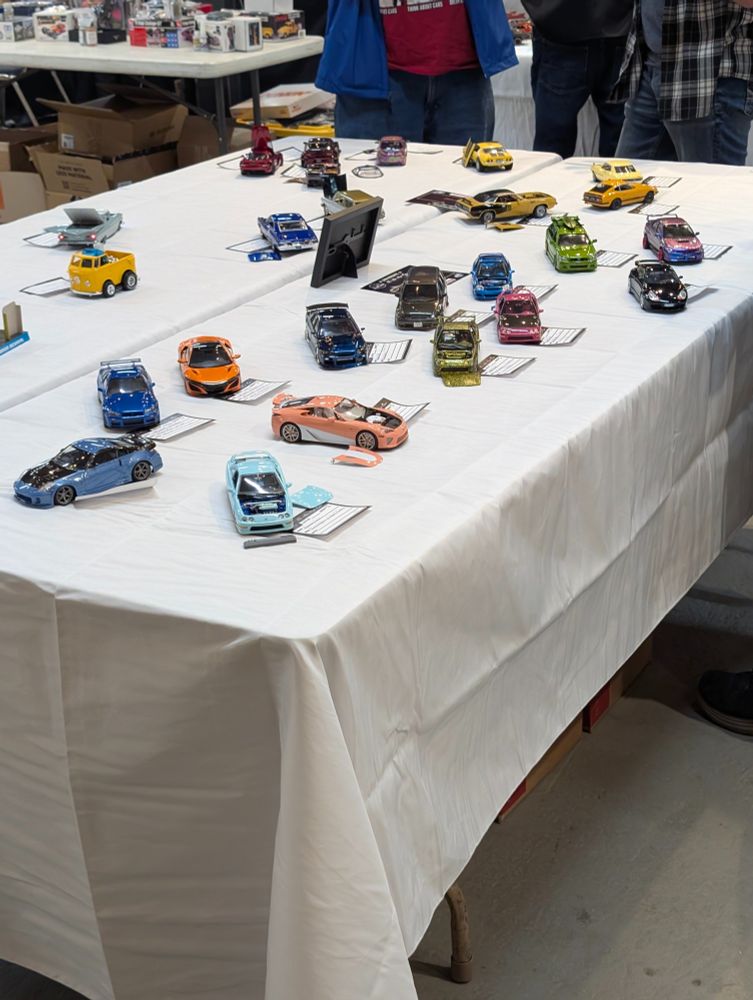 Model cars on a table, being judged
