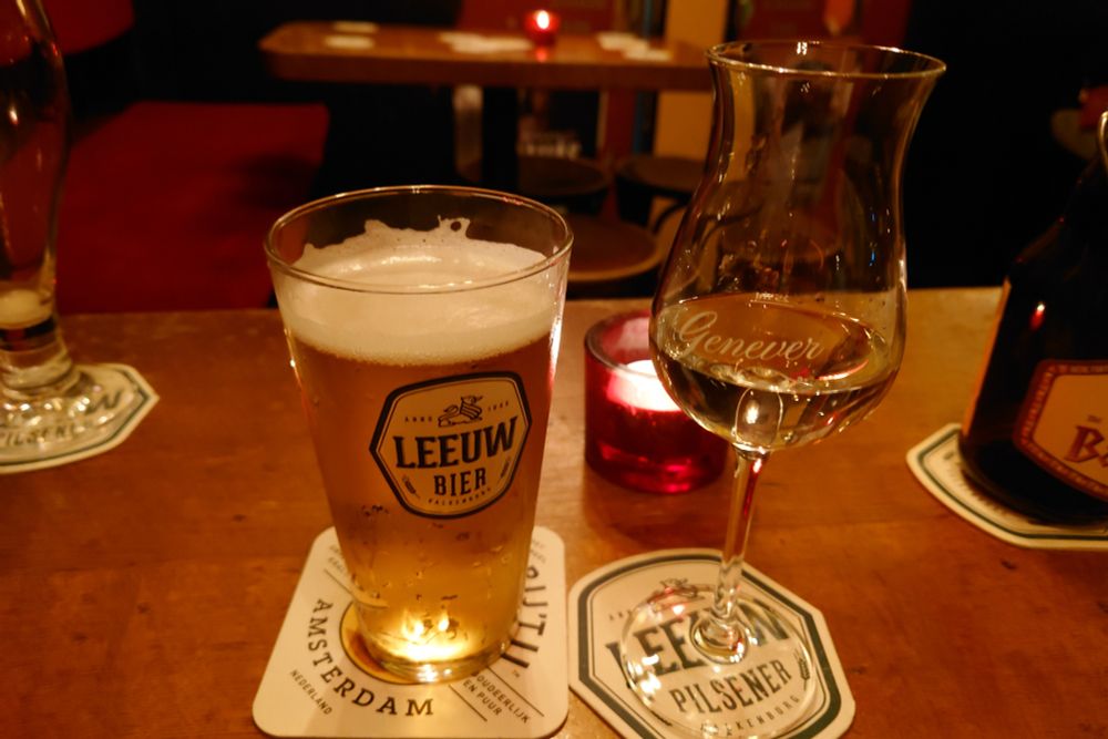 A glass of Leeuw beer and a glass of genever