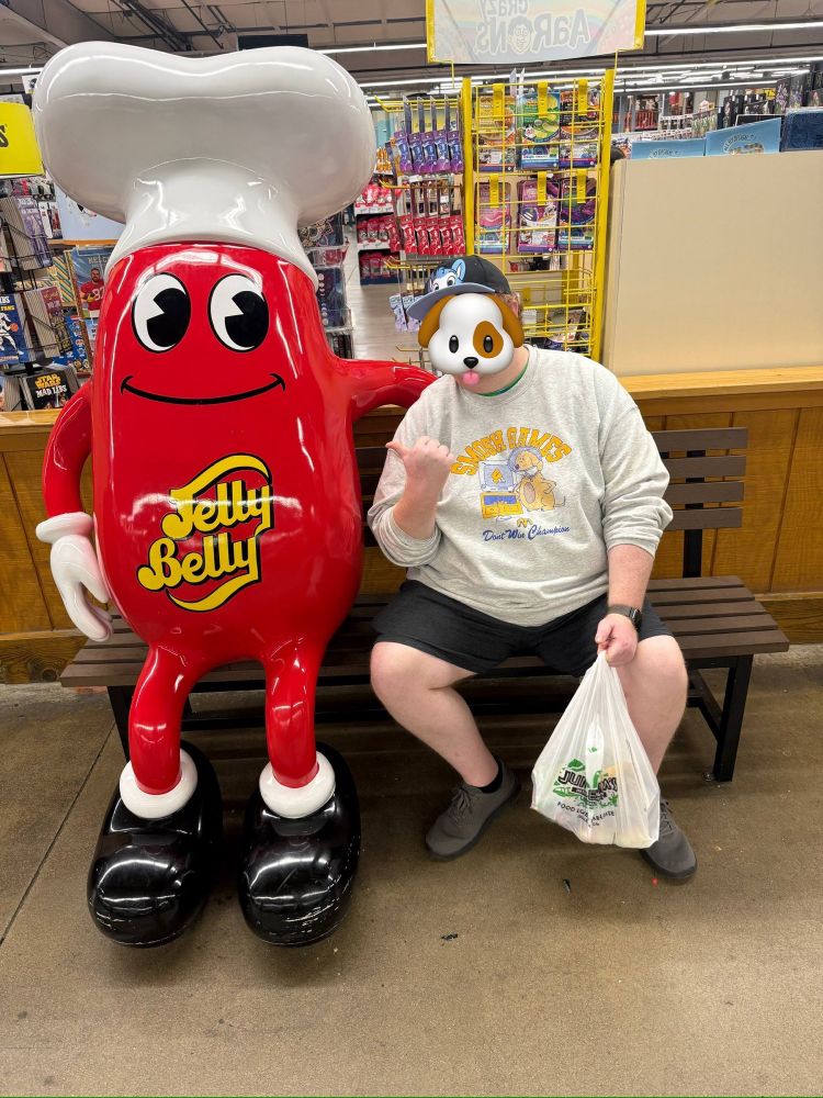 Br0pup sitting next to a Jelly Belly man (a giant red jelly bean with the Jelly Belly logo on his belly)