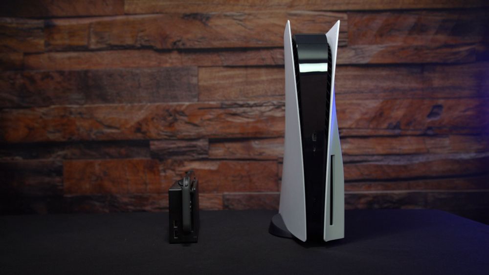 Shows a Switch next to a PS5, demonstrating the PS5 is several multitudes larger than the Switch.