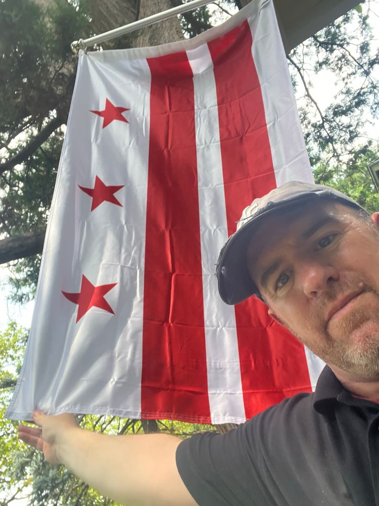 Selfie with DC Flag behind me.