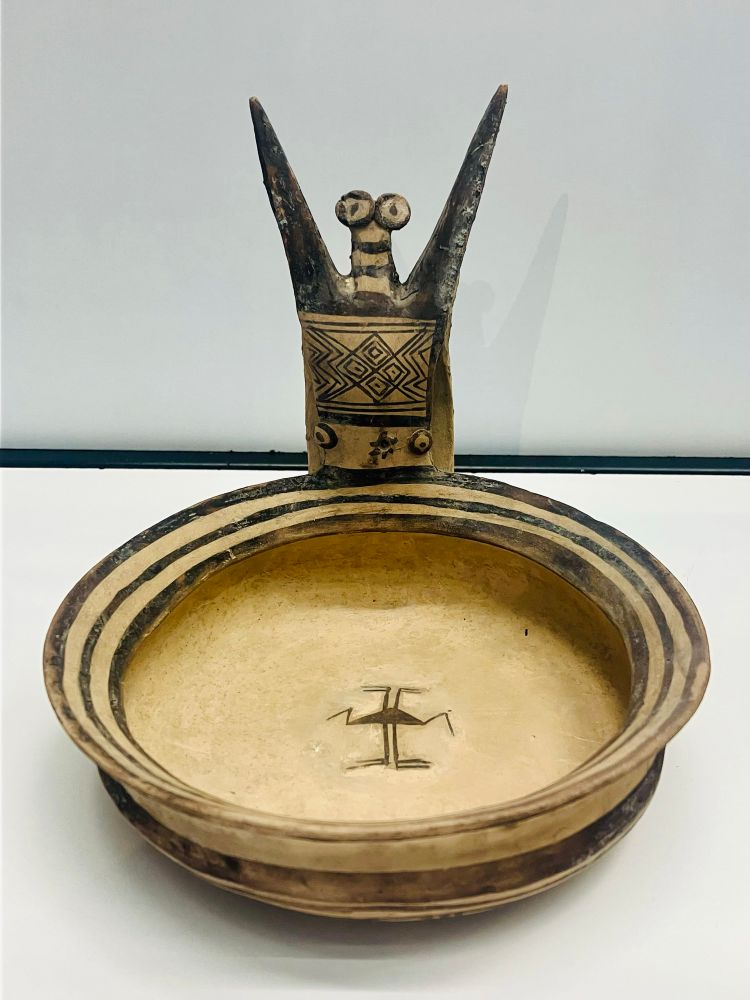 A Daunian kyathos from Fiesole in Tuscany. It’s a flat bowl with an anthropomorphic handle which looks like someone holding their arms in the air 