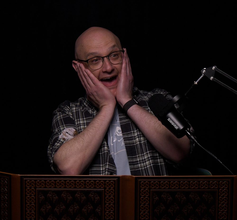 A still of me, Dungeon Mastering an episode of Adventure is Nigh. I am looking shocked and happy with hands slapped against my face and my mouth open.