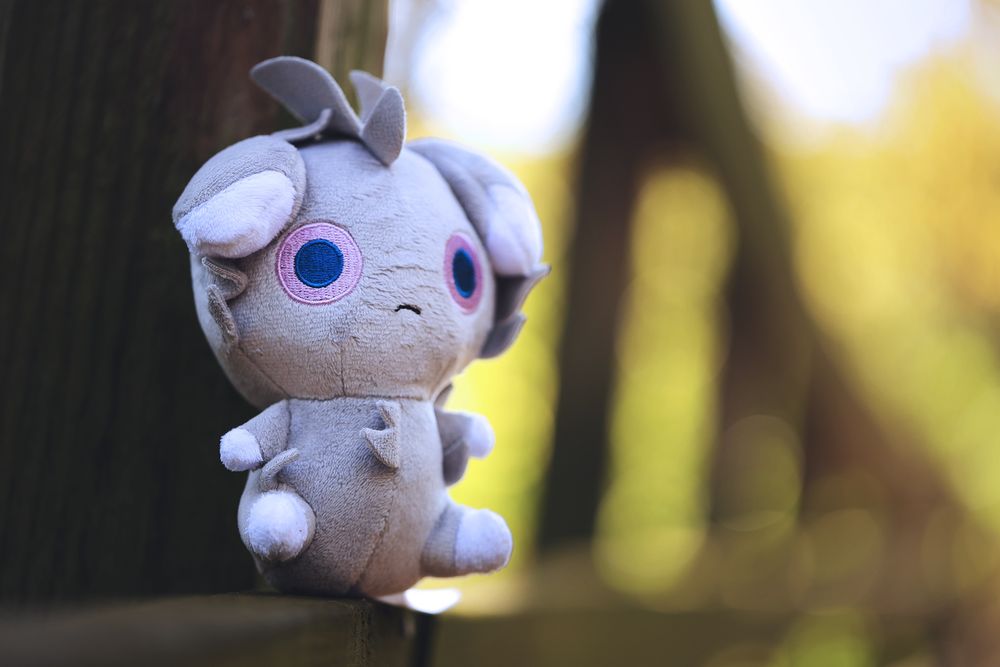 2013 Espurr Pokémon Doll sitting on a wooden bench 