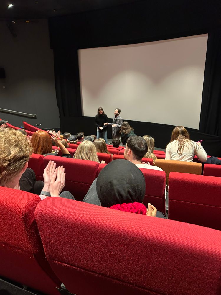 A cinema with two people making a speech. 