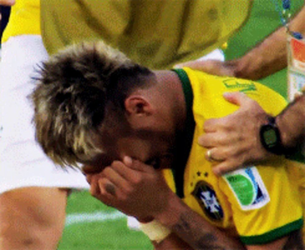 a soccer player with the number 3 on his shirt is being helped off the field