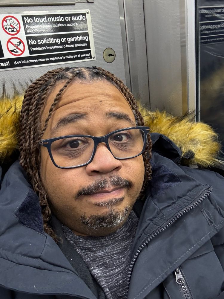 Just got my twists freshly done.  Wearing my winter coat with the fur hood to stay warm.  Trying my best to show bear face.  A traditional half or partial smile with your lips tucked in…