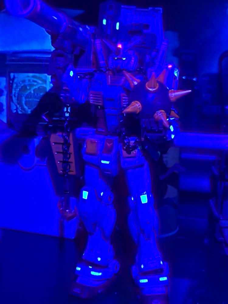 The FAT CAT glowing in the dark under a blacklight. The red for the head cameras and the yellow for the eyes were my favorite places to use it. Some of the gold parts also glow a little. 