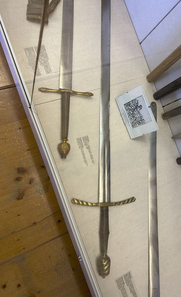 Photo of some blunt tipped executioner's swords on display.
