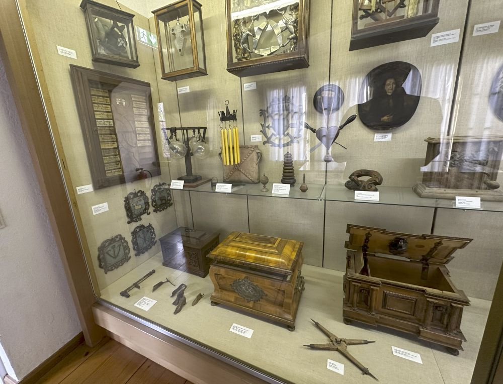 Photo of a display cabinet of various guilds' relics and physical tokens.