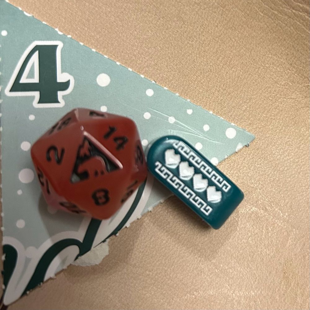 Two dice in a pale leather dice tray. Behind them is a green triangle with the number four in dark green print. The die on the left is a translucent orange-red d20 with wisps of red, orange, yellow, and white; the print is black and the Adventure Dice logo is showing on the top face. The die on the right is a pearlescent turquoise infinity-shaped d4 with sparkles embedded; the print is white and four solid pixel-art hearts are showing on the top face. 