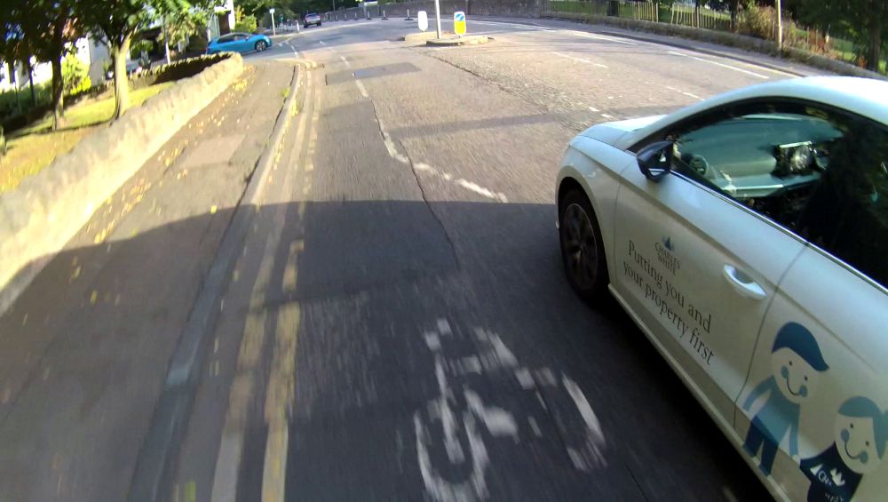 The car alongside me, with "Charles White, Putting you and your property first" written on the passenger door.