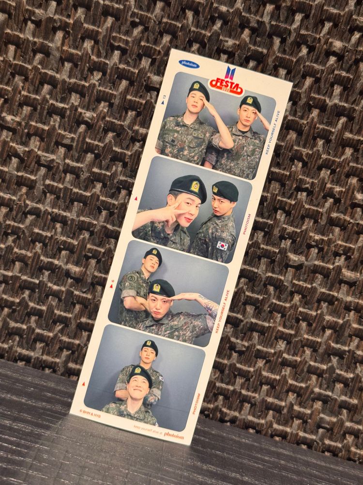 A photo booth strip of Jungkook and Jimin in army fatigues.
