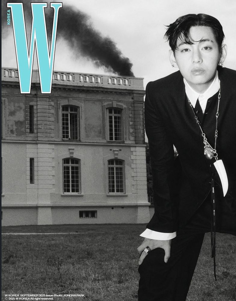 V in front of a burning house for W korea