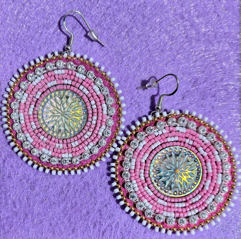 pink and white powwow earrings with gold and white edging against purple felt background 