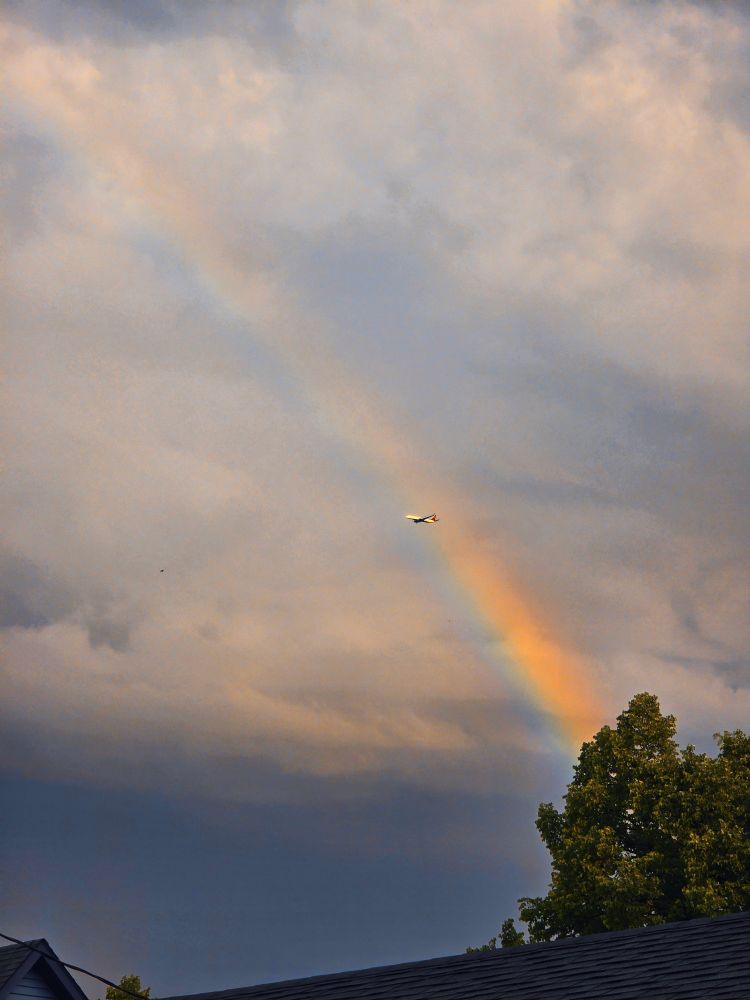 Delta plane flying in front of a rainbow after storms on July 17 2025