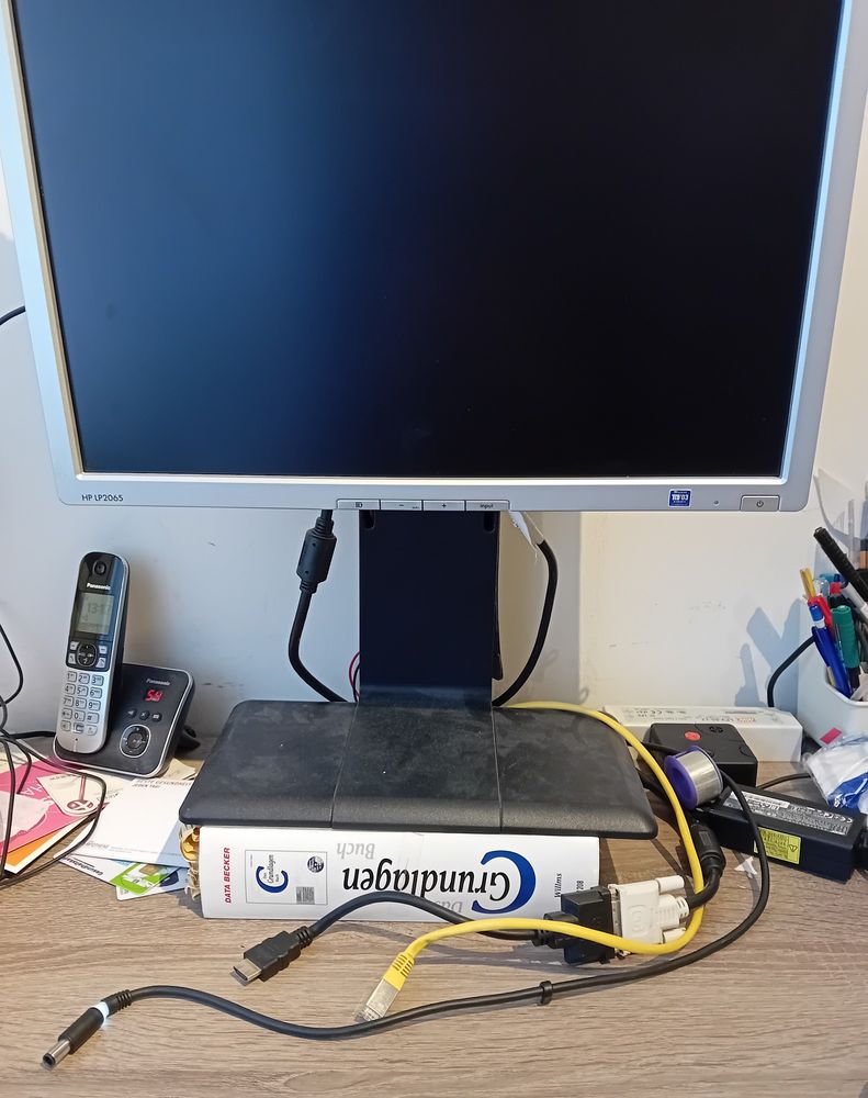 A thick book under a monitor foot