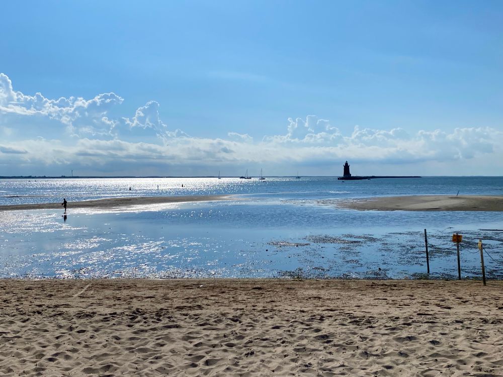 View of the beach and the water - Harbor Refuge Lighthouse is small in the distance 