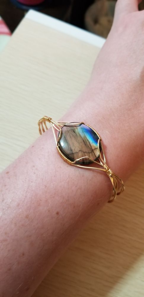 The bracelet from before on my wrist, showing the green, brown, and blue striations of the labradorite. 