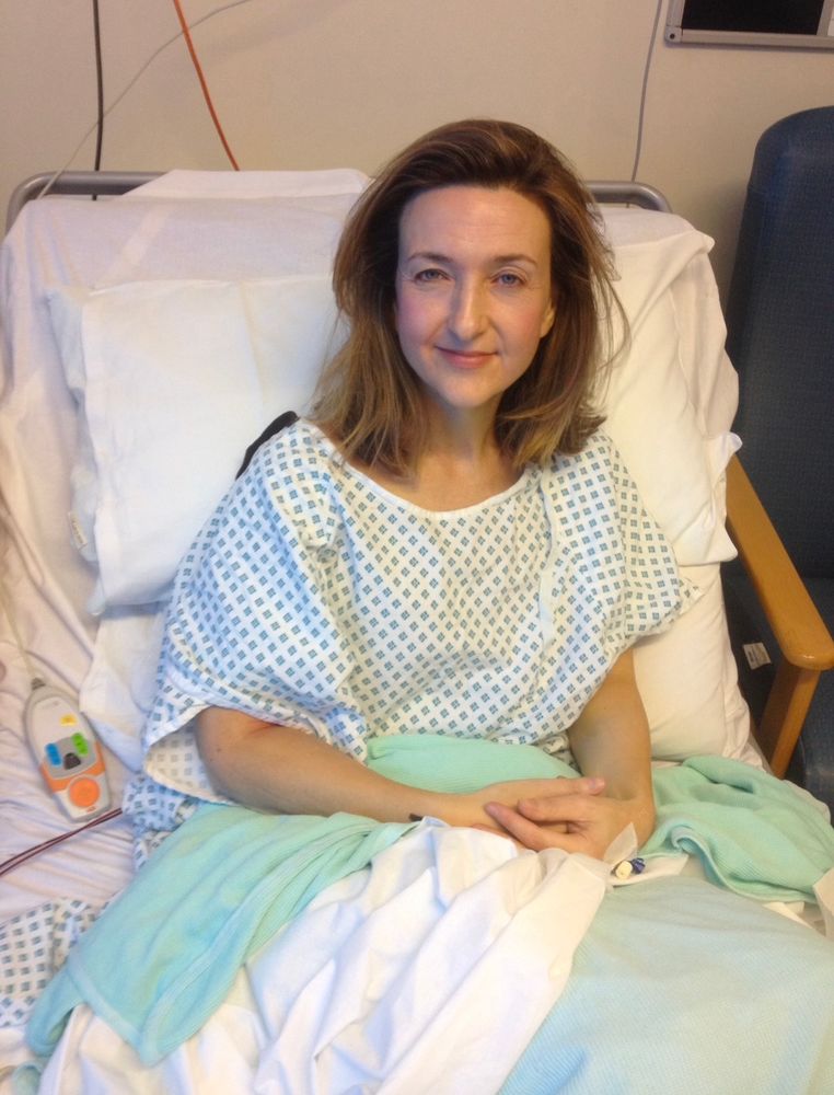 Me in a hospital bed wearing one of those standard NHS hospital gowns preparing for a mastectomy 