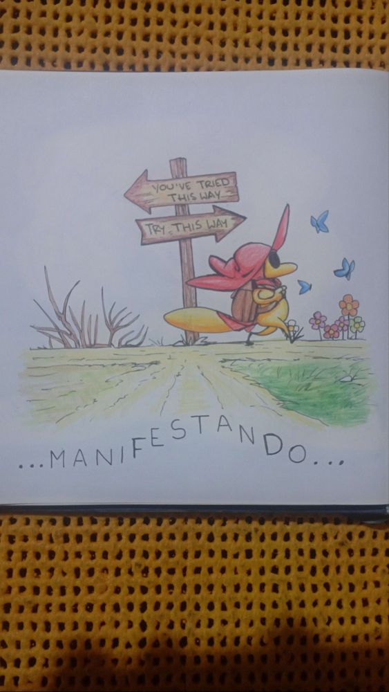 Sir Balderich following a sign that says to follow a path he has not taken yet while carrying a backpack. This path looks much greener and peaceful. The word "Manifesting" is written in spanish.