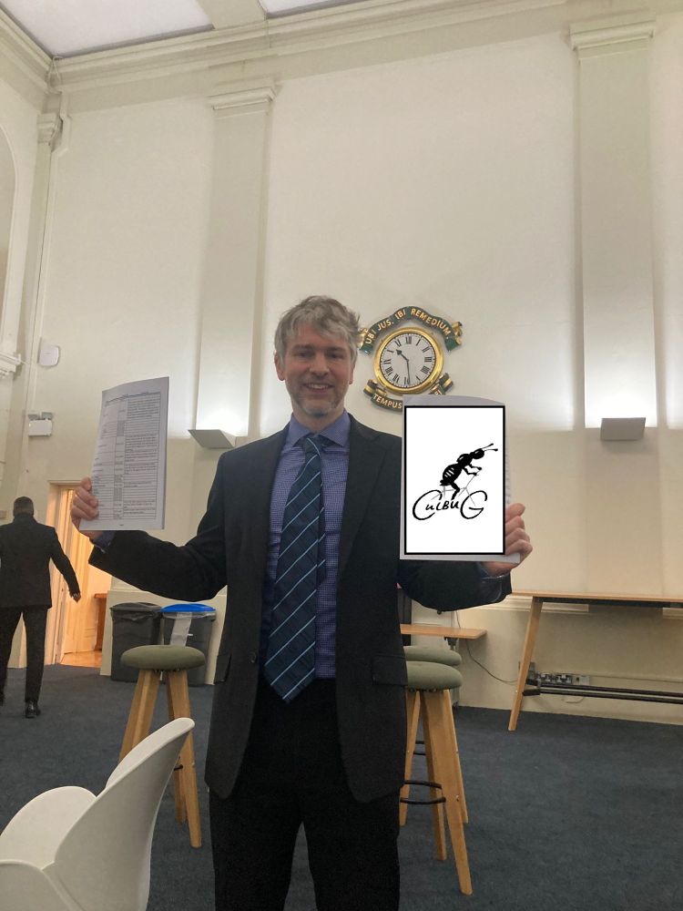 Aidan Reilly, uncharacteristically suited, holding the printed internet petition and written petition collected at Europa School outside Oxfordshire County Council. Slight oopsy in that contact details could be made out on the written petition so it has been tastefully amateurishly corrected with a copy-paste CulBUG logo covering that piece of paper.