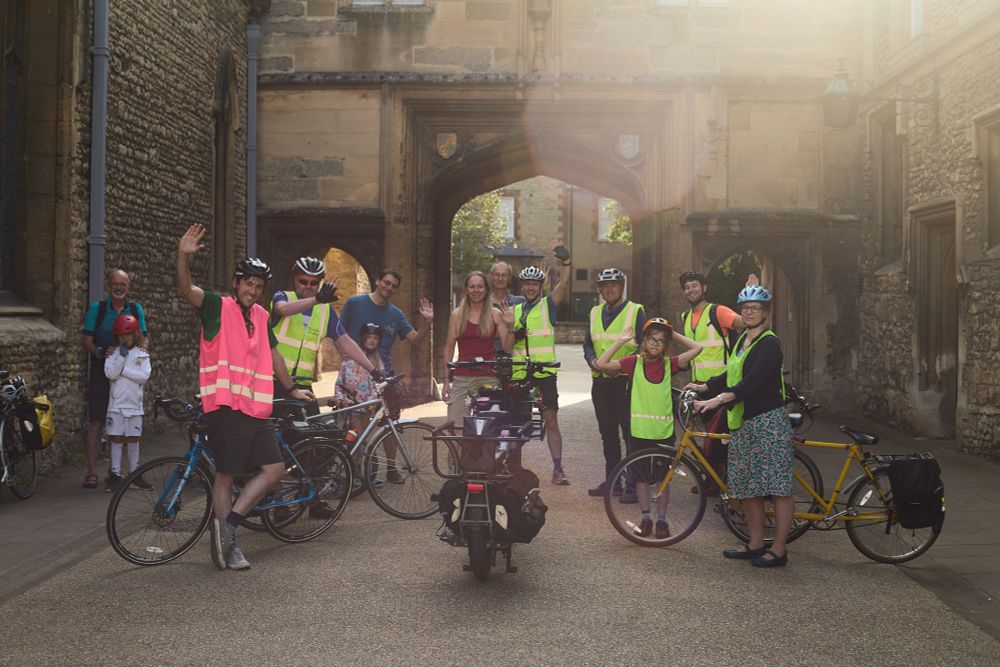 Bike bus participants waving with their bikes by the Abingdon Guildhall