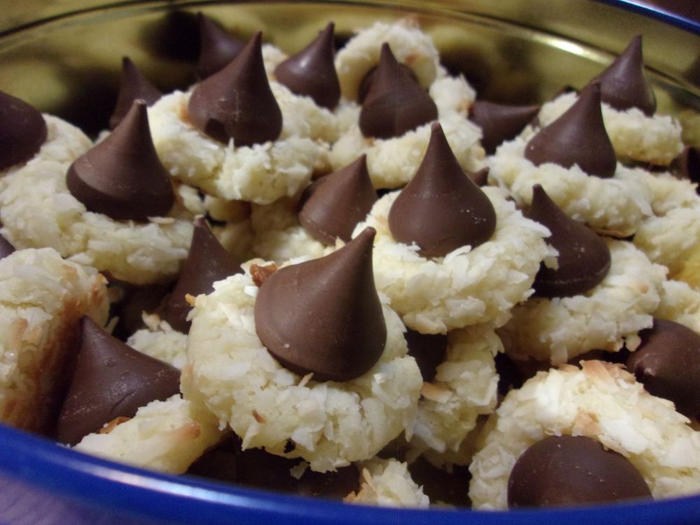 Cookie tin full of macaroon kiss cookies, which are a coconut macaroon with a Hershey's kiss on top. 