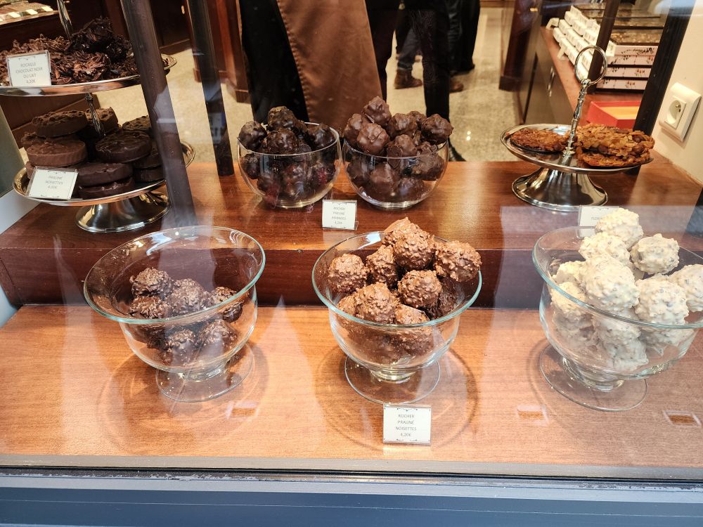 Storefront window in Paris. Chocolates!!! Dark, Milk and White chocolate balls in separate glass bowls. Yum! 😋 