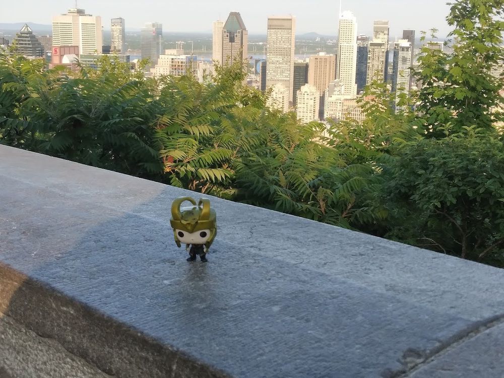 Pocket Loki Funko Pop on Mount Royal looking down on Montreal. 
