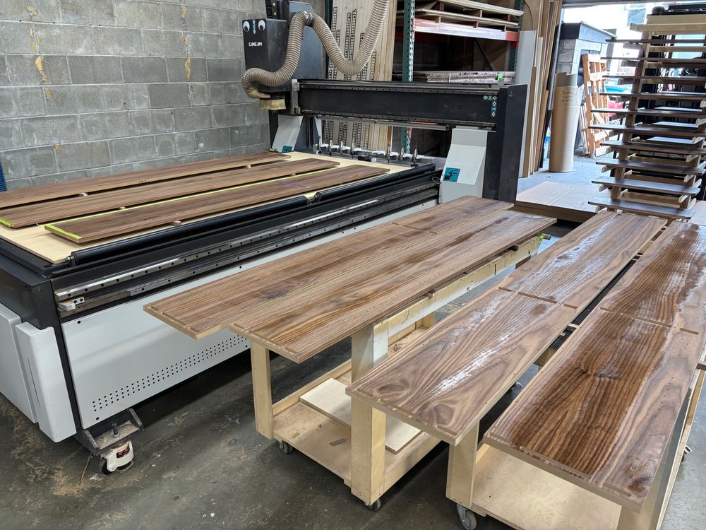 Several walnut mdf gables laid out to dry after receiving the first coat of clear finish. 