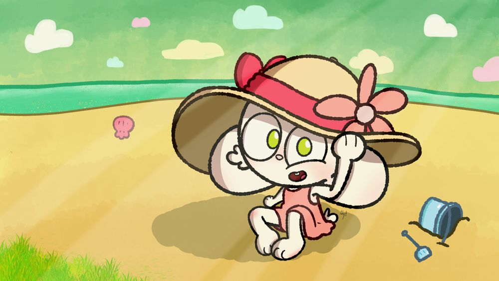 robyn wears a sun hat and dress sitting on the beach