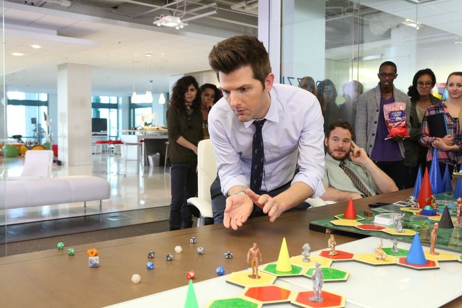 Ben Wyatt from the TV series Parks and Recreation. Rolling dice while playing the fictional board game Cones of Dunshine.