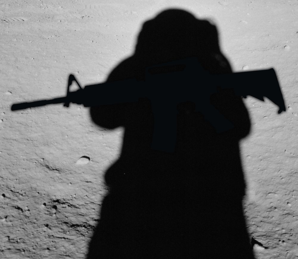 The shadow of an astronaut, but he's carrying a gun