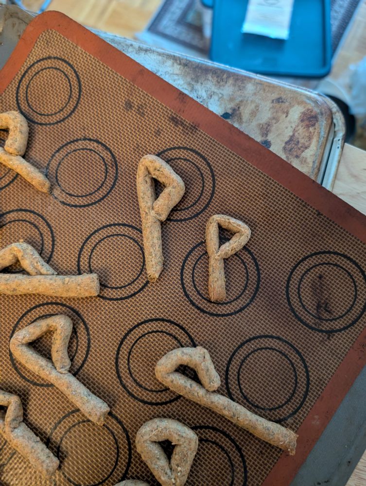 Breadsticks on a silpat baking mat, shaped into a P of all sharp angles, the rune Wunjo. 