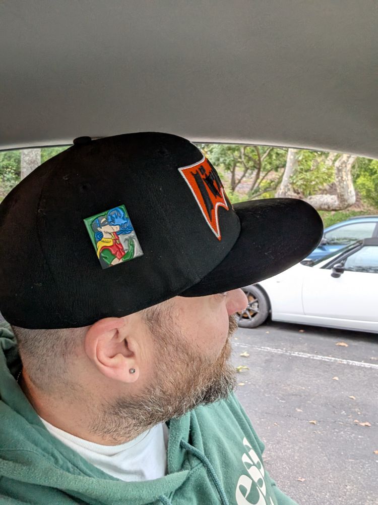 Same dude showing you the pin on the side of the batman hat of Batman and Robin kissing. 
