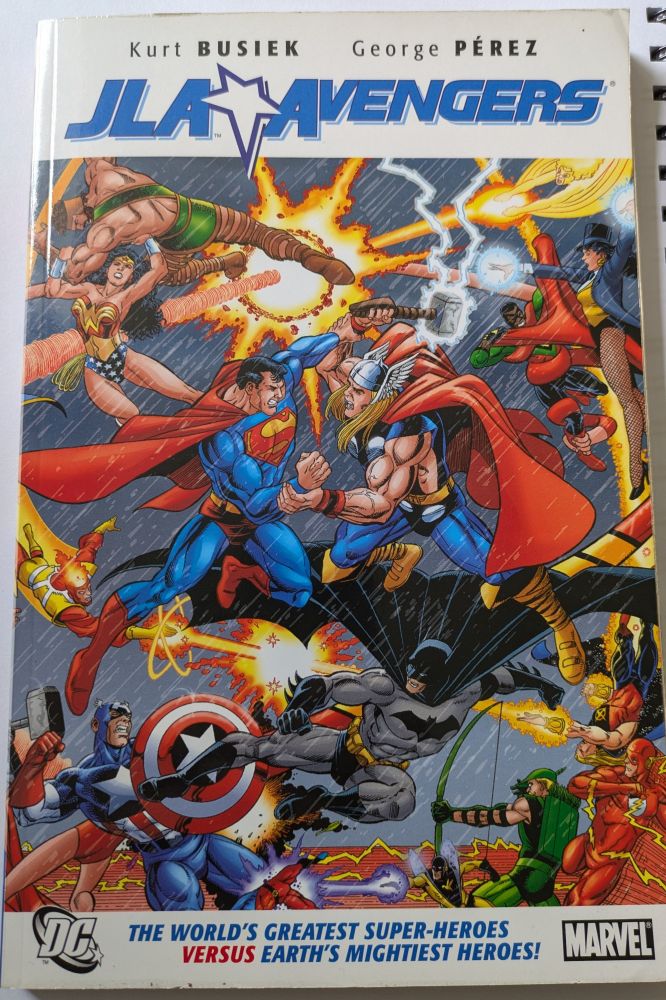 A copy of JLA Vs Avengers By Kurt Busiek and George Pérez 