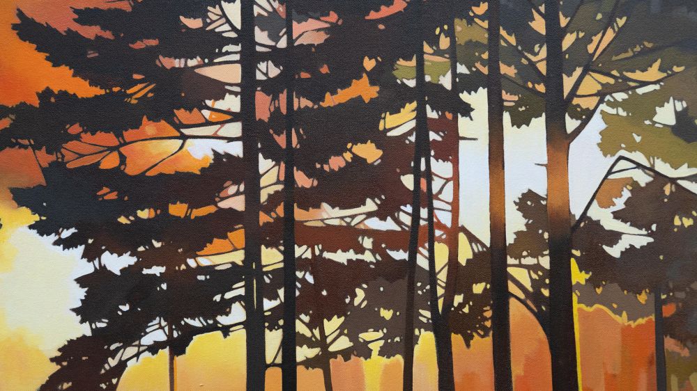 Close up of a painting of a forest fire silhouetted behind trees. 