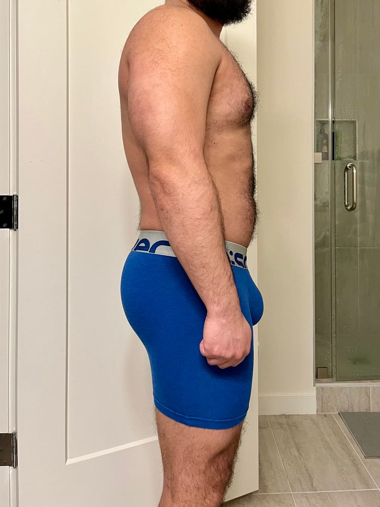 Shirtless side profile of my body, wearing compression shorts. My triceps look good, as do my chest and midsection.