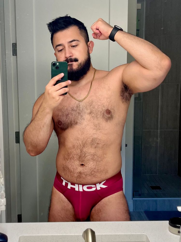 Selfie wearing a print that says "THICK"