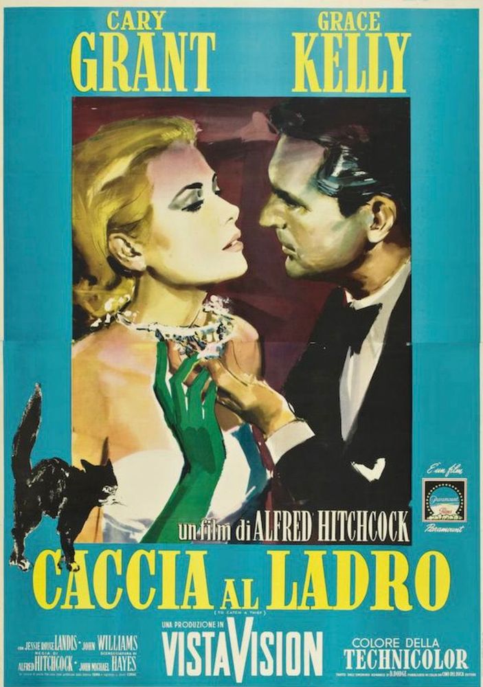 Cary Grant examines the pearl necklace around Grace Kelly's neck, nearby a black cat arches its back