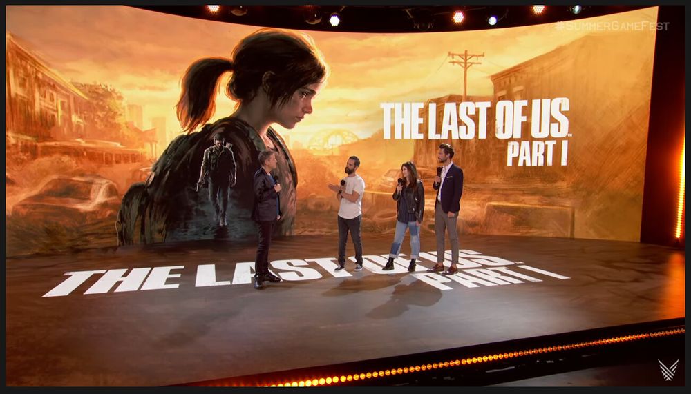 The Last of Us Part I reveal, with Geoff Keighley, Neil Druckmann, Ashley Johnson and Troy Baker on stage (left to right) at the Summer Game Fest 2022. Behind them on a huge curved screen you can see the key art I did for The Last of Us Part I.