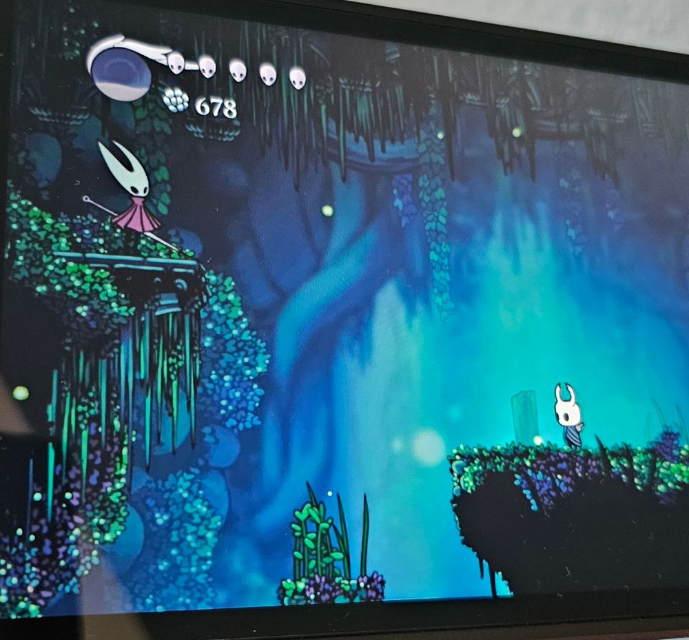 Hollow Knight on Switch 2, with both, the hero of Silksong and the one from the original game on one screen.