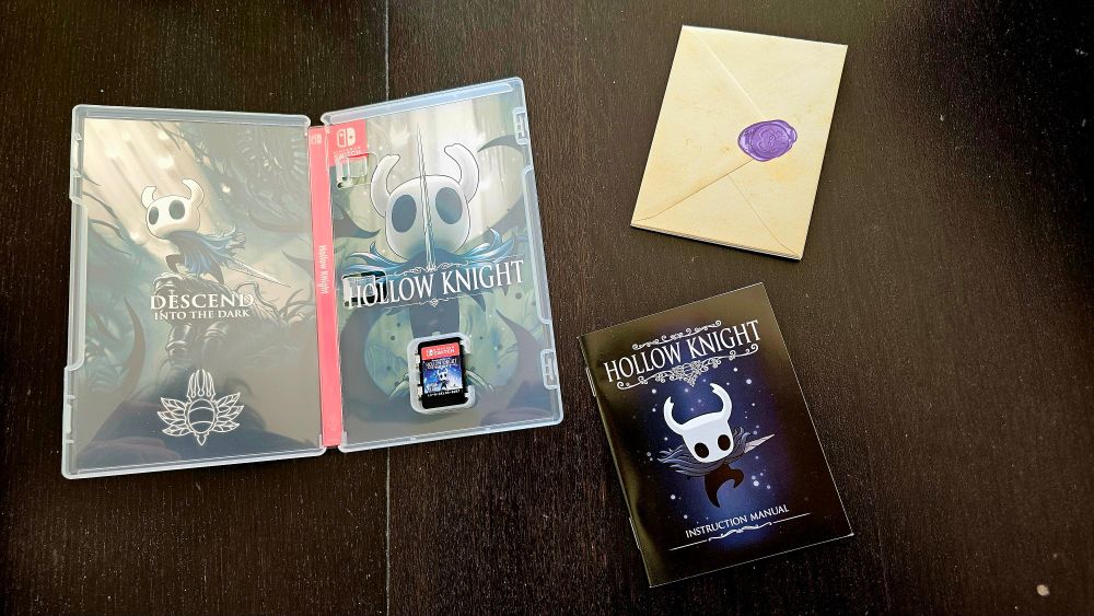 Opened game box, with alternative reverse sleeve cover art, a physical mini poster map, a physical manual, and the game cadridge itself. 