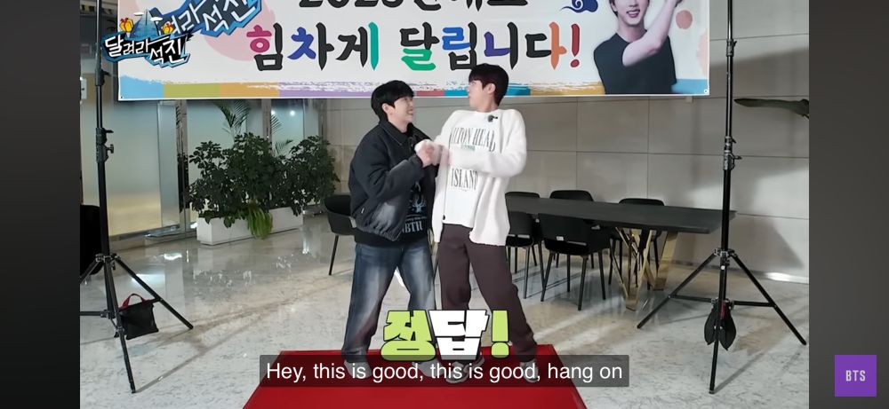 Sandeul and Seokjin are standing next to each other about to hear about the mission they have to do